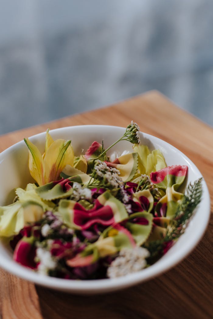 The Art of Drawing Readers In: Your attractive post title goes here Vibrant floral and herb salad in a white bowl, perfect for fresh summer meals.