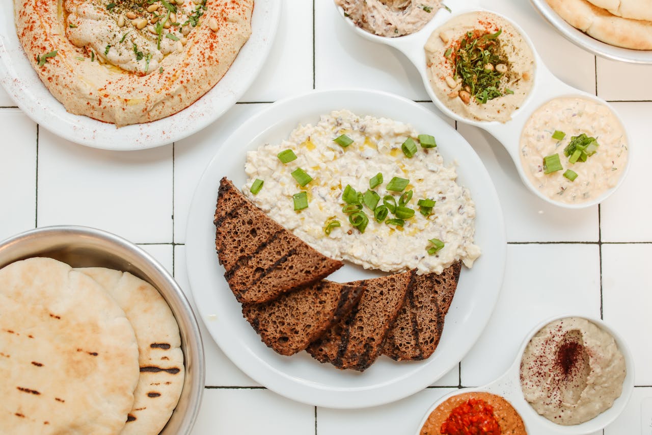services-04 Top view of Mediterranean dips with rye bread, showcasing variety and delicious presentation.